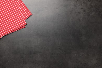 Photo of Checkered tablecloth on grey background, top view. Space for text