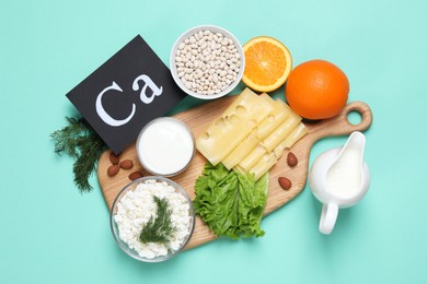 Photo of Food high in calcium. Flat lay composition with different products on turquoise background
