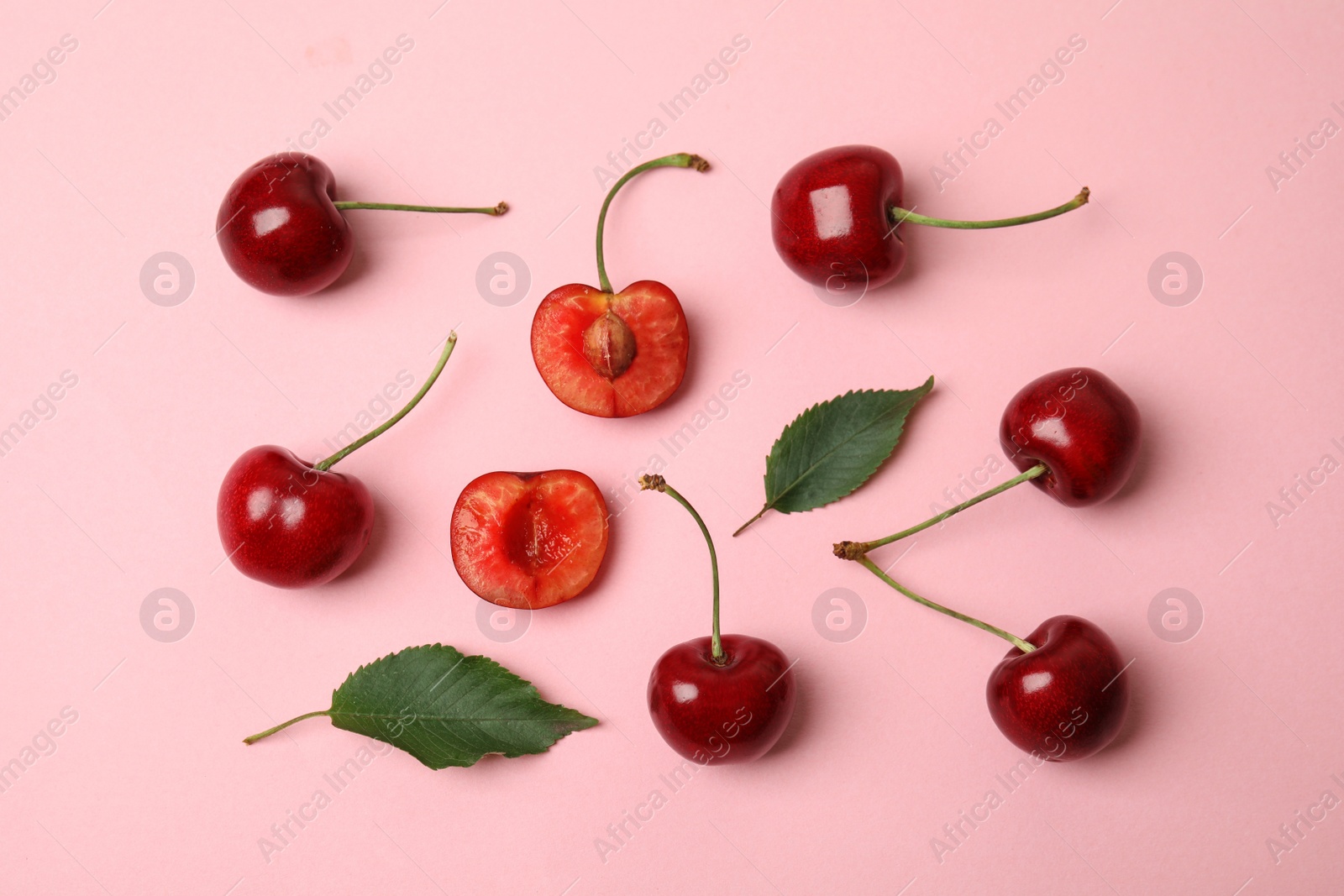 Photo of Flat lay composition with ripe sweet cherries on pink background