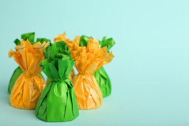 Photo of Candies in colorful wrappers on light blue background