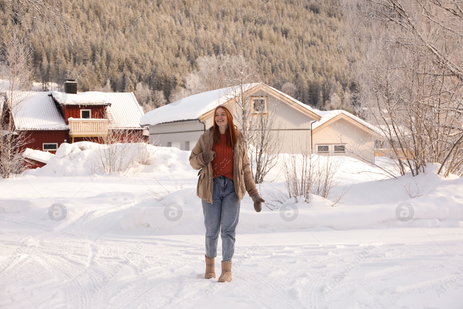 Photo of Beautiful young woman on snowy day outdoors. Winter vacation