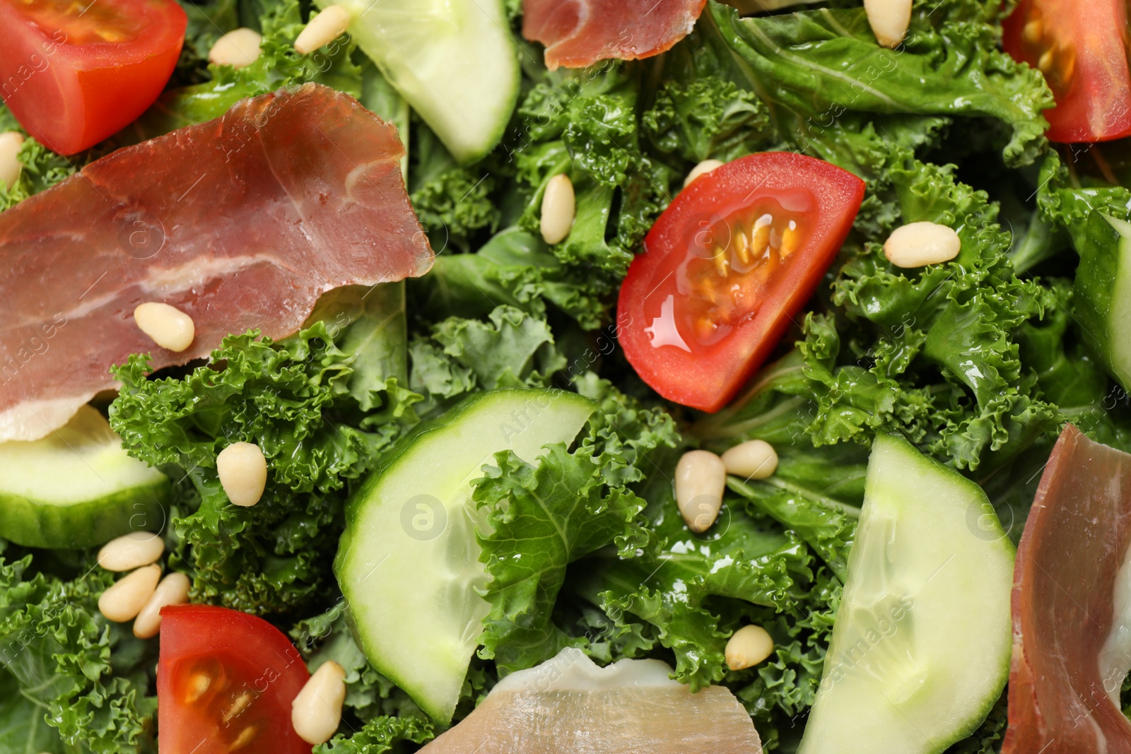 Photo of Delicious salad with kale leaves as background, closeup