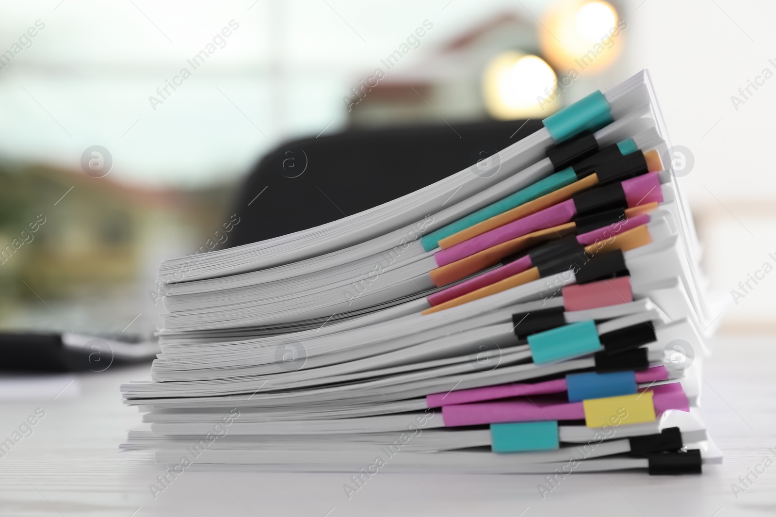 Photo of Stack of documents with paper clips on office table