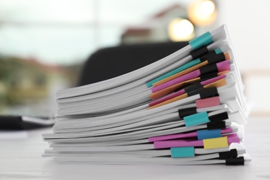 Stack of documents with paper clips on office table