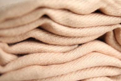 Photo of Folded beige soft cashmere fabric, closeup view