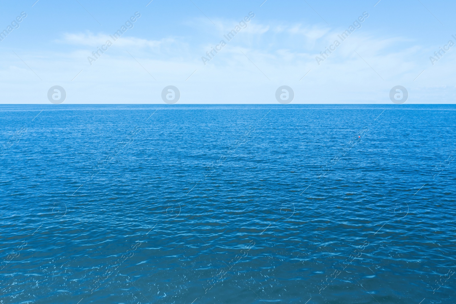 Image of Beautiful ripply sea under blue sky with clouds