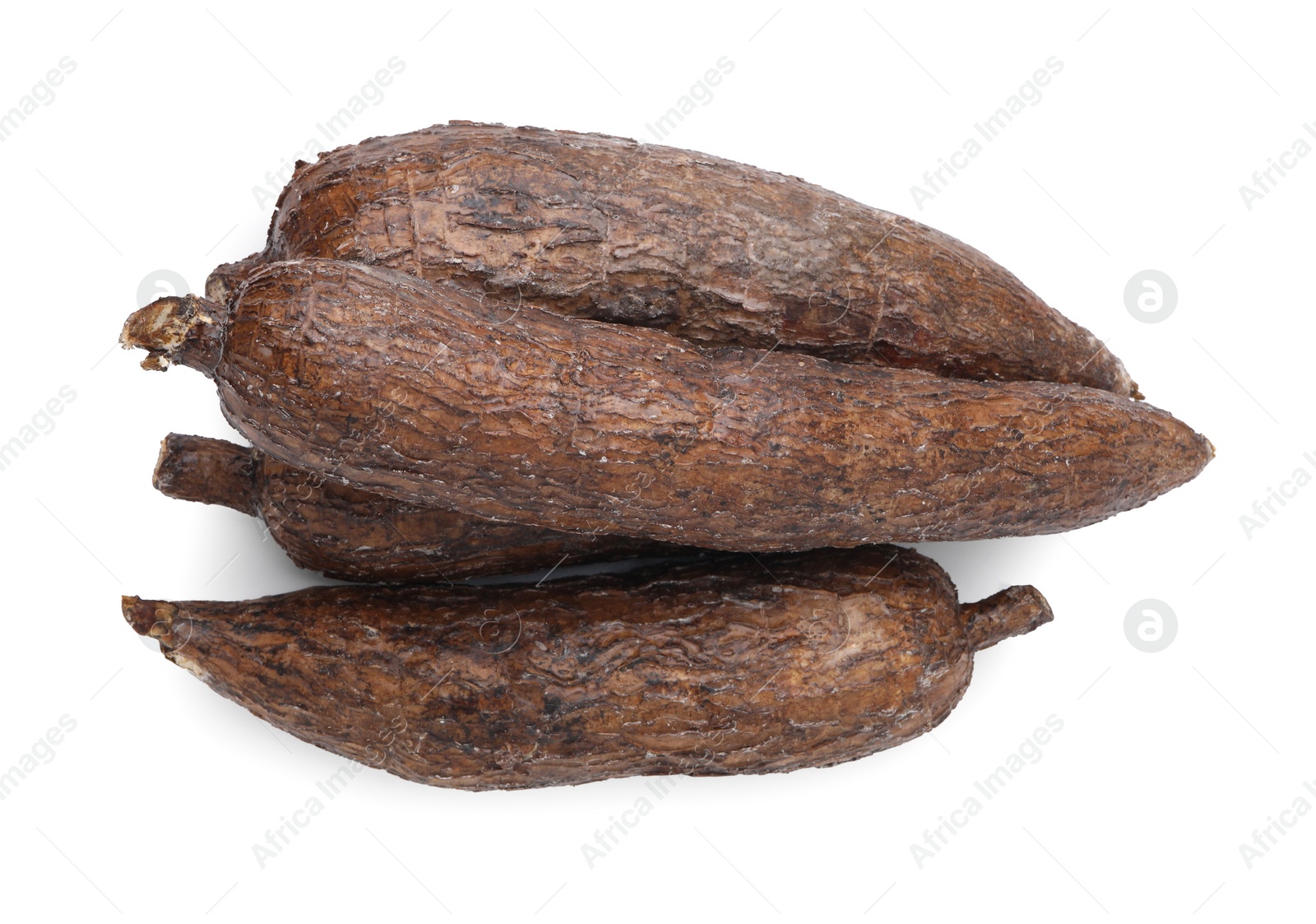 Photo of Many whole ripe cassava roots isolated on white, top view