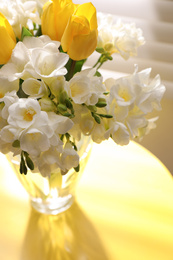 Photo of Beautiful bouquet with fresh freesia flowers in vase on table near window