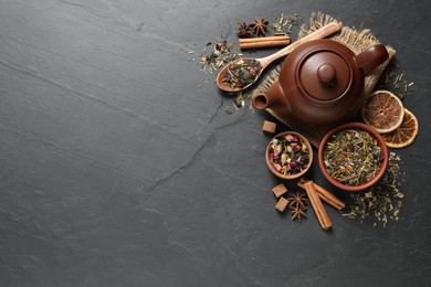 Photo of Flat lay composition with different dry teas on grey table, space for text