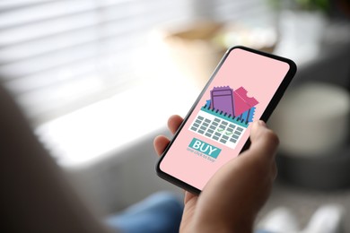 Image of Woman buying tickets online via mobile phone at home, closeup