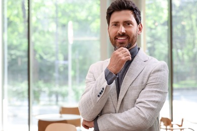 Portrait of handsome stylish man in office