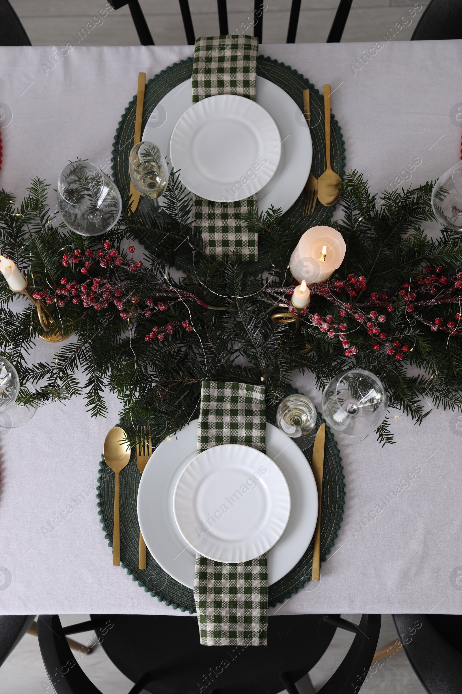 Photo of Christmas table setting with festive decor and dishware, top view