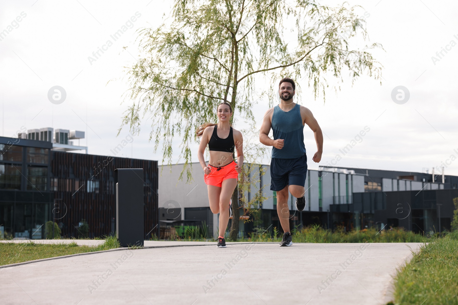 Photo of Healthy lifestyle. Happy couple running outdoors, space for text