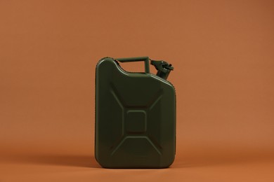 Photo of New khaki metal canister on brown background