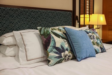 Photo of Beautiful pillows on bed in hotel room