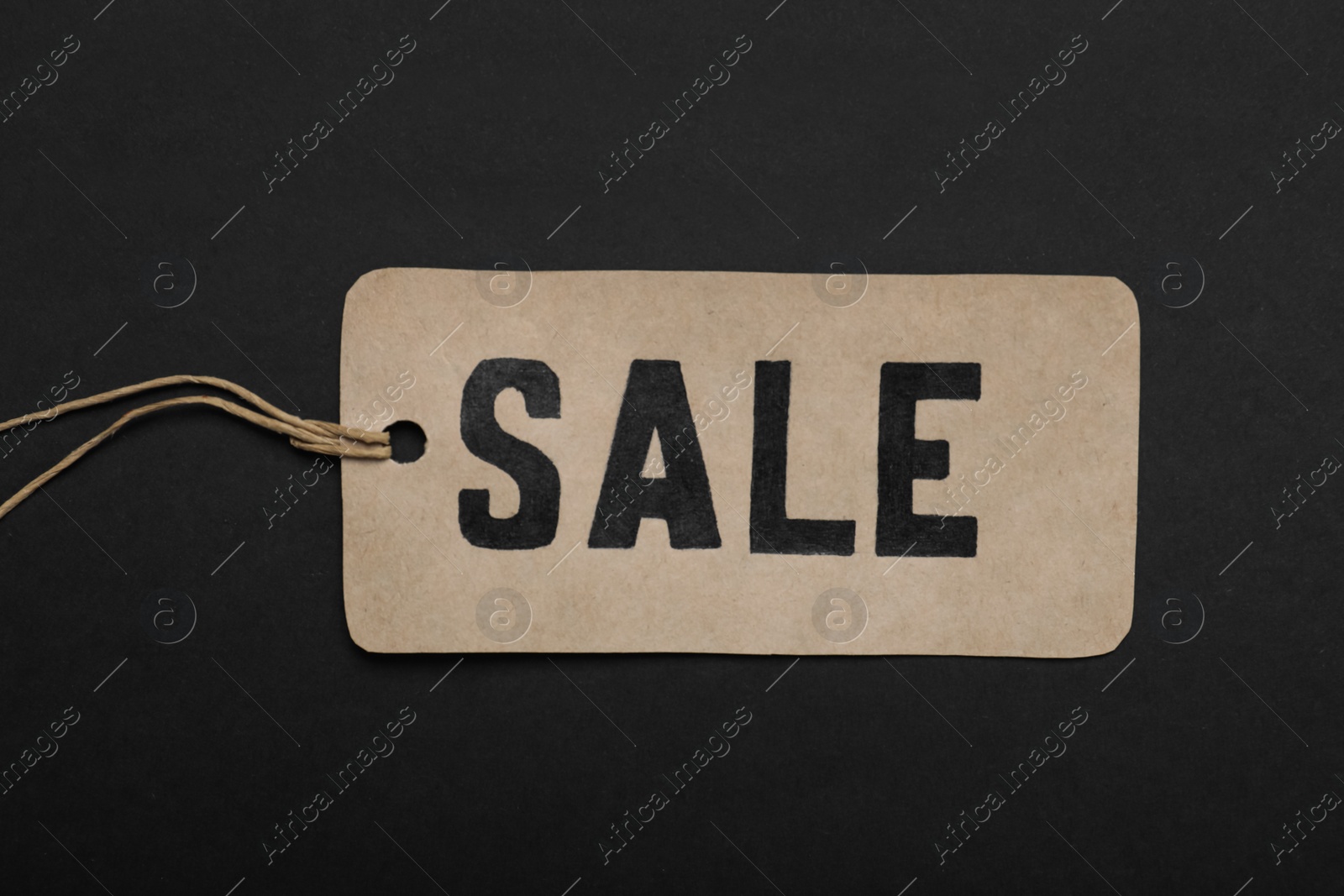 Photo of Sale tag on color background, top view. Black Friday