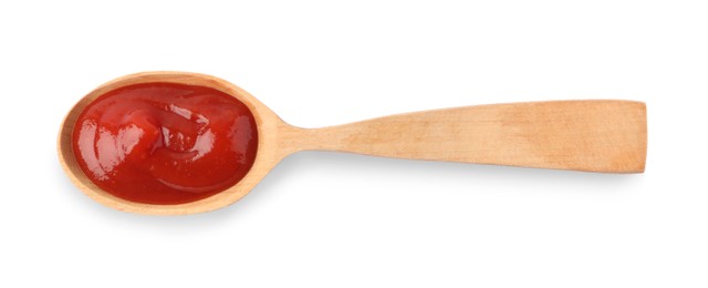 Ketchup in wooden spoon isolated on white, top view
