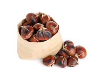 Photo of Paper bag with tasty roasted edible chestnuts on white background