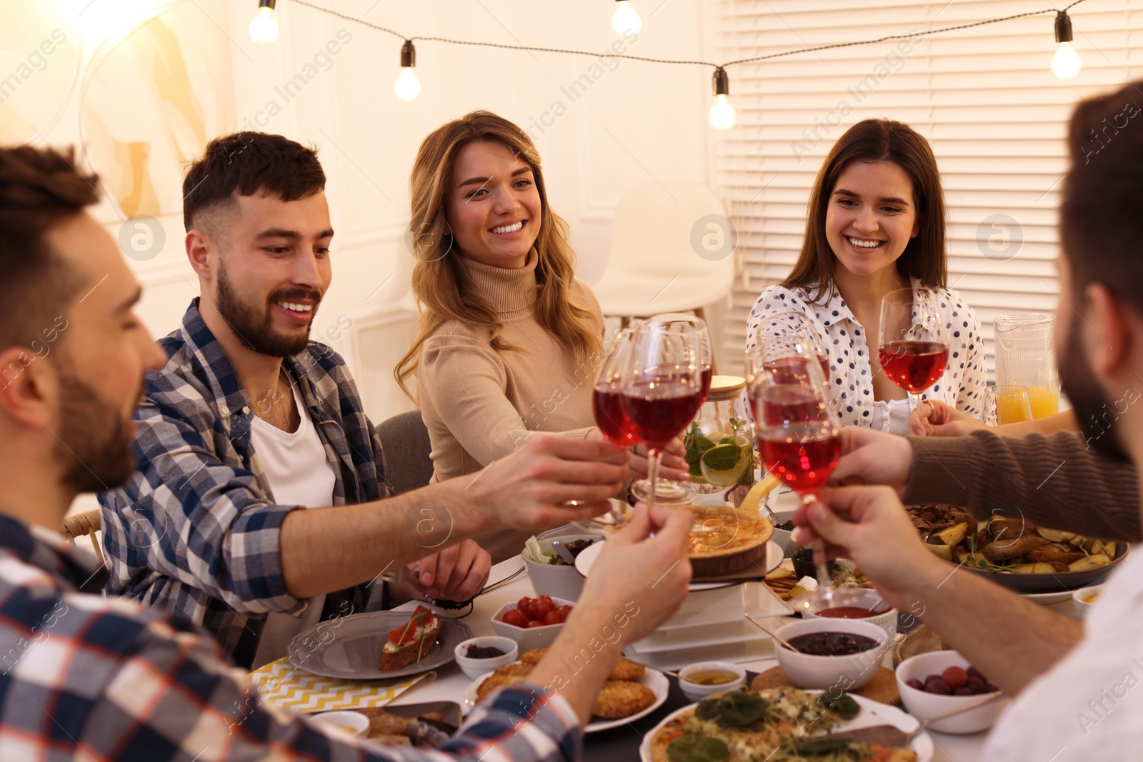 Photo of Group of people having brunch together at table indoors