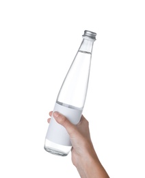 Woman holding glass bottle with soda water on white background, closeup
