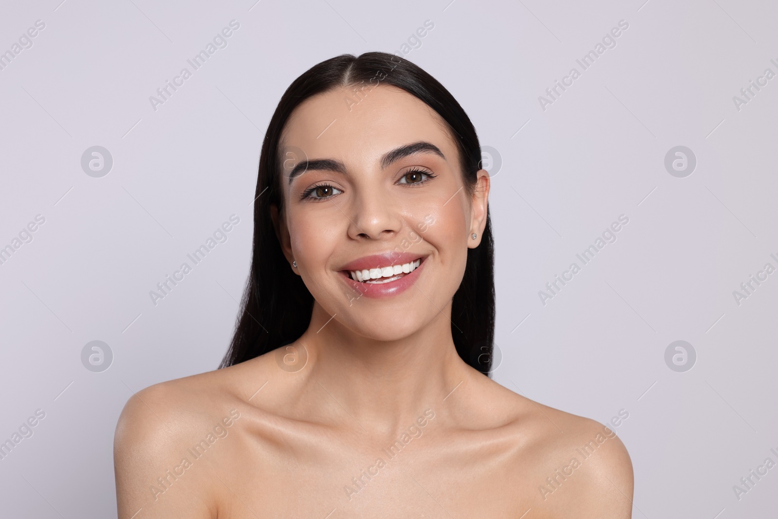 Photo of Portrait of attractive young woman on light grey background. Spa treatment