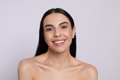 Portrait of attractive young woman on light grey background. Spa treatment