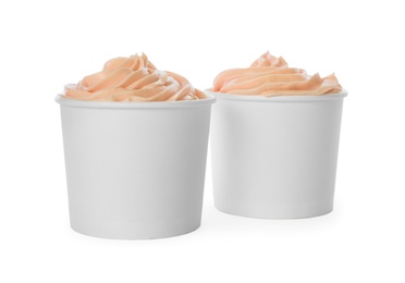 Cups with tasty frozen yogurt on white background