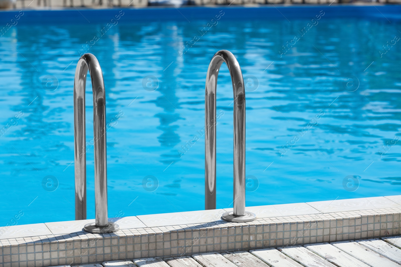 Photo of Modern swimming pool with step ladder outdoors