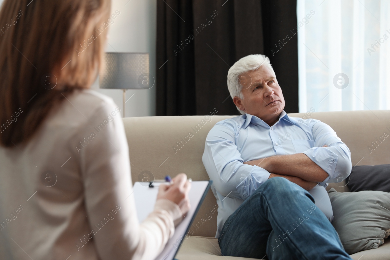 Photo of Professional psychotherapist working with patient in office