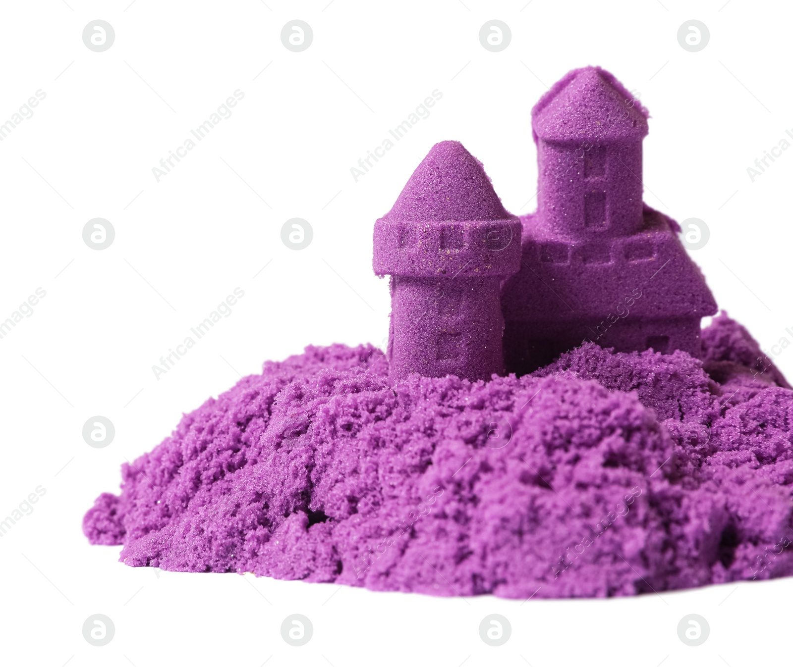 Photo of Castle made of purple kinetic sand isolated on white