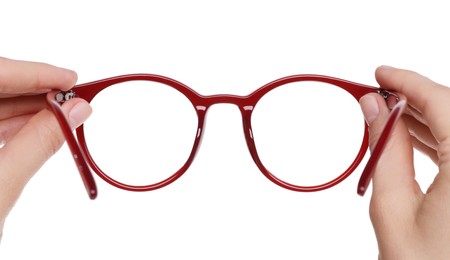 Photo of Woman holding stylish glasses with red frame on white background, closeup