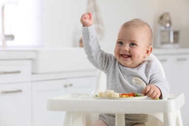 Cute little baby eating healthy food at home. Space for text