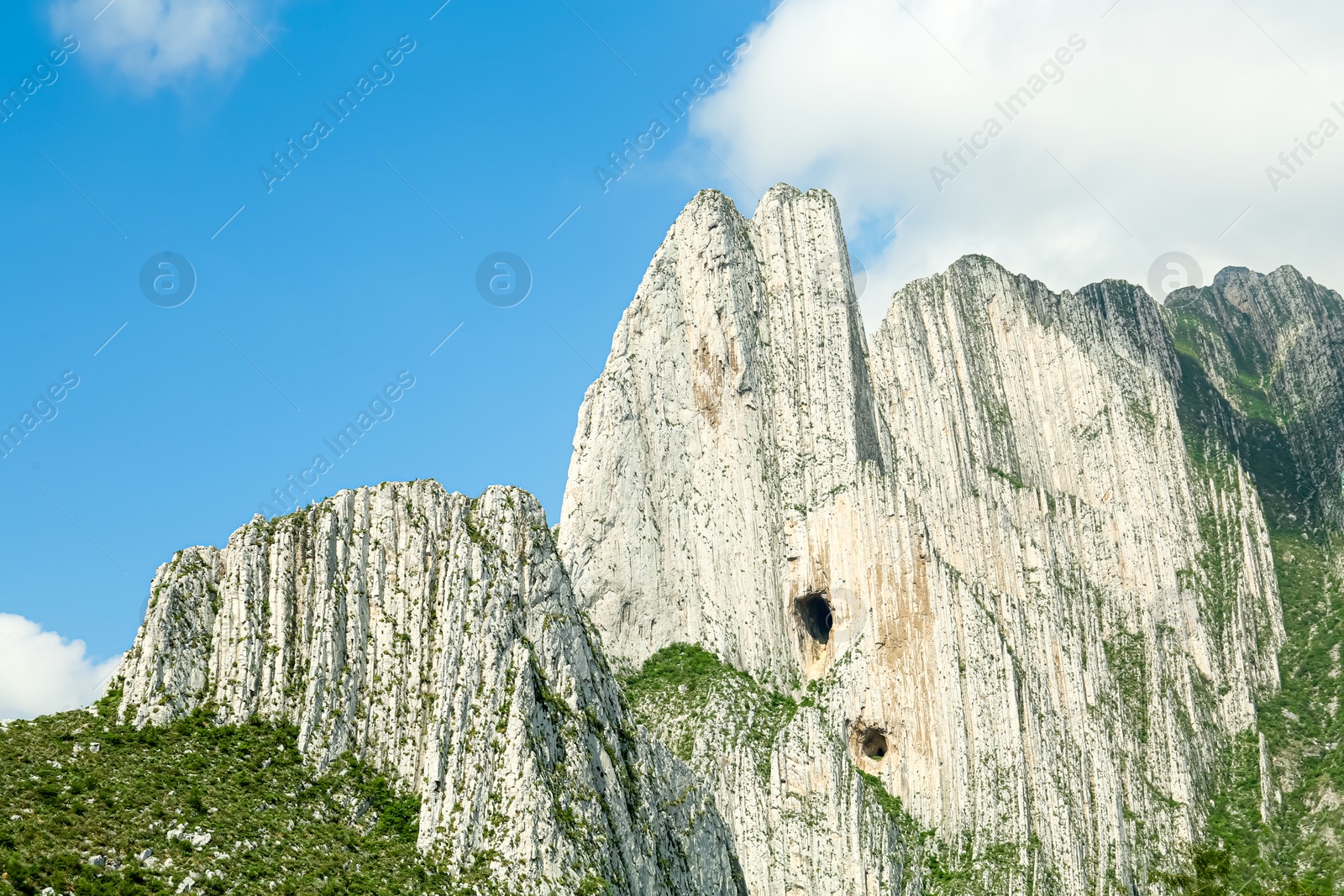 Photo of Picturesque view of beautiful mountains under blue cloudy sky