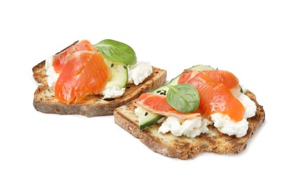 Photo of Delicious sandwiches with cream cheese, salmon, cucumber and spinach on white background