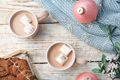 Flat lay composition with hot cocoa drink on wooden background