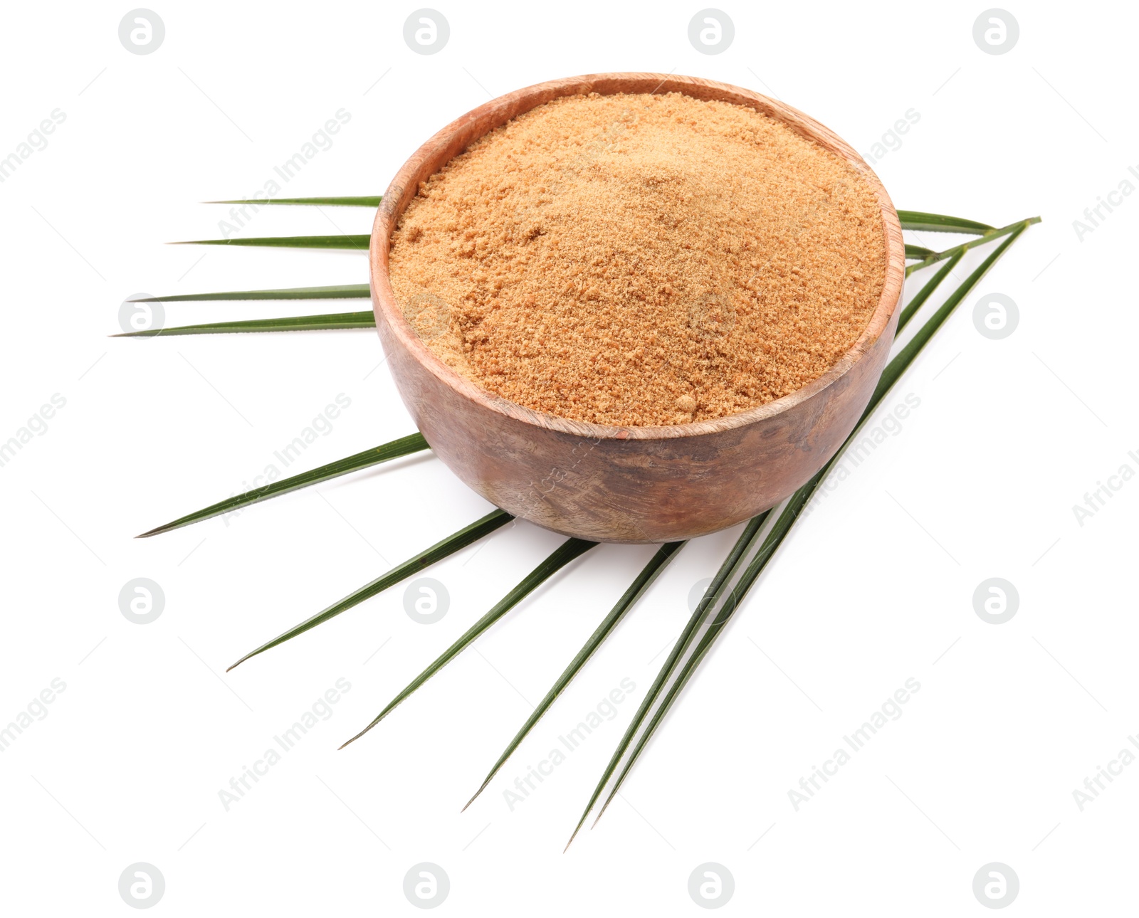 Photo of Coconut sugar in bowl and palm leaf isolated on white