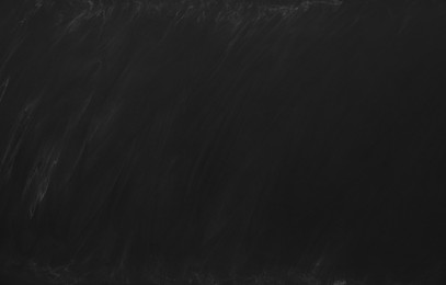 Photo of Dirty black chalkboard as background. School equipment