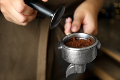 Photo of Barista making espresso using professional coffee machine, closeup
