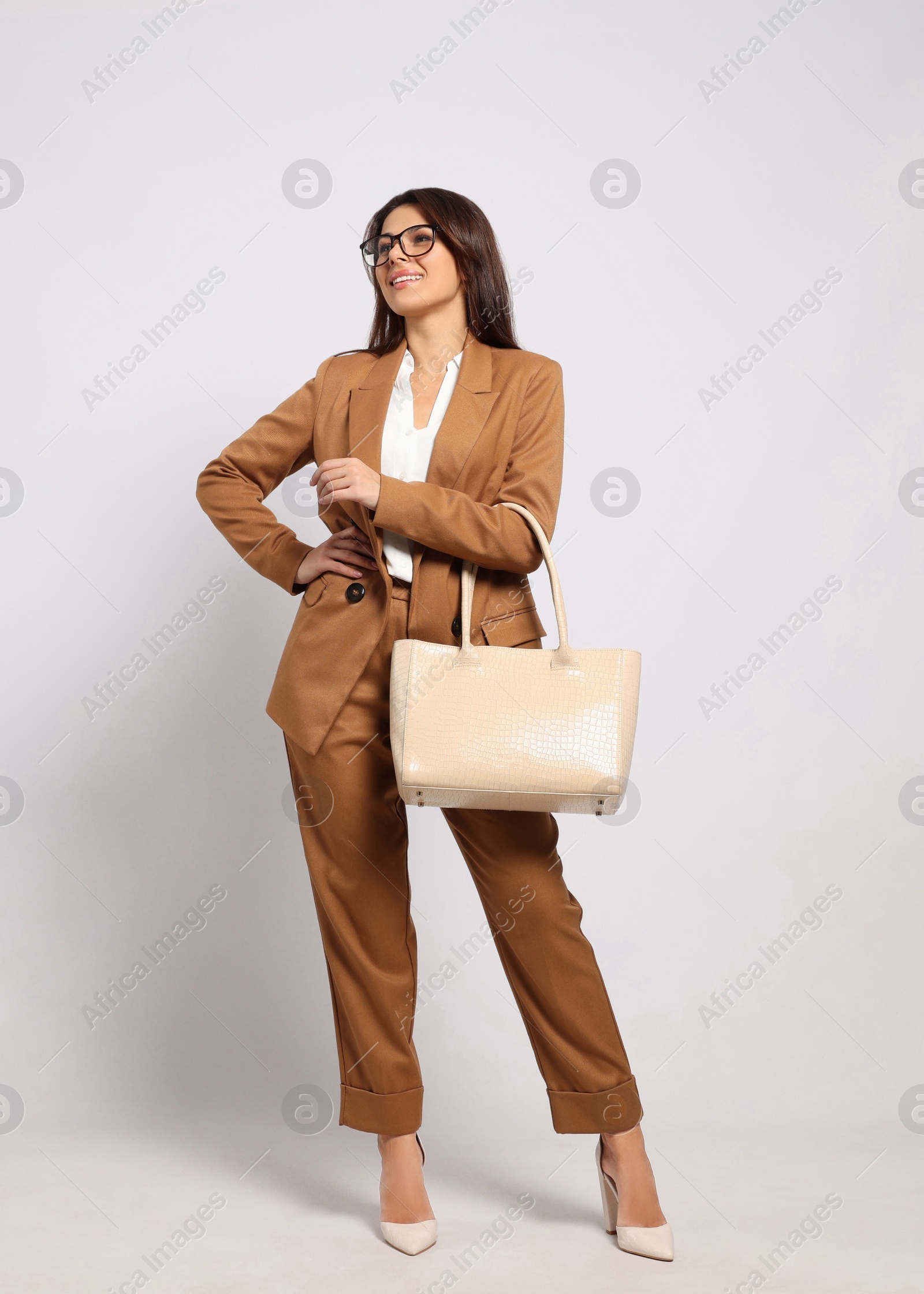 Photo of Young woman with stylish bag on white background