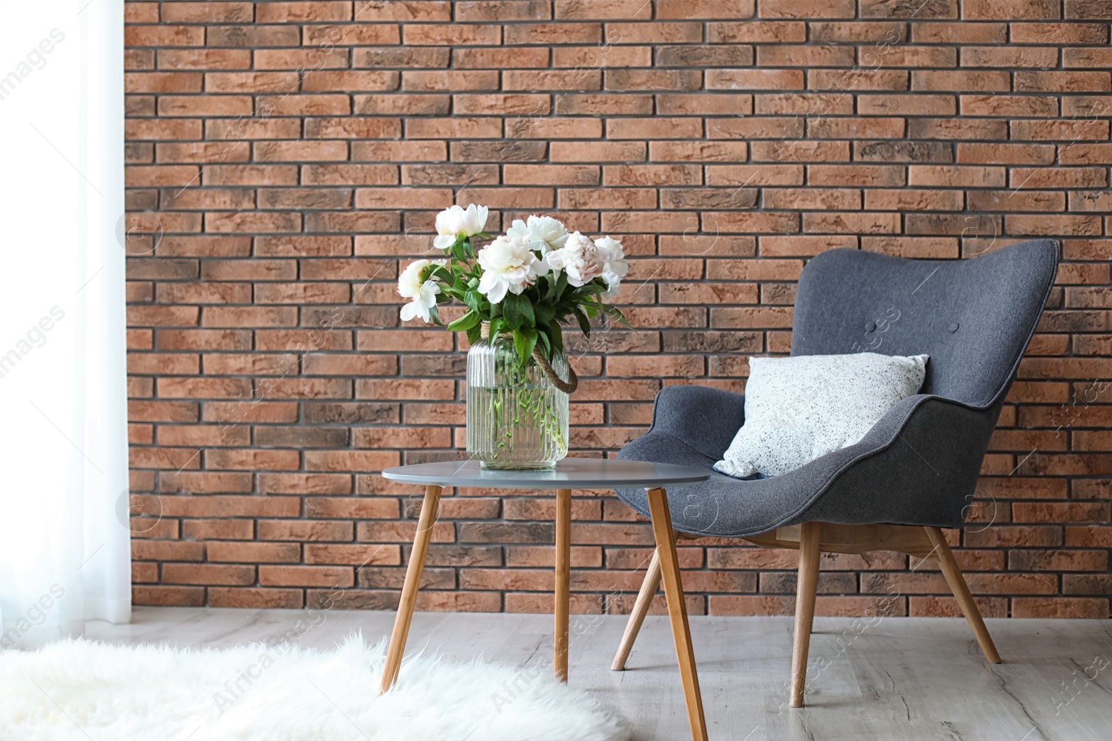 Photo of Room interior with armchair and beautiful flowers