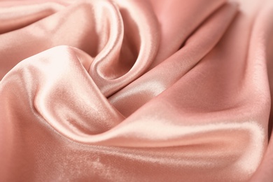 Photo of Texture of rose gold silk as background, closeup