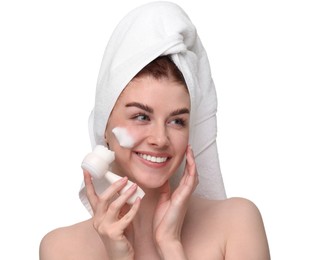 Photo of Young woman washing face with brush and cleansing foam on white background