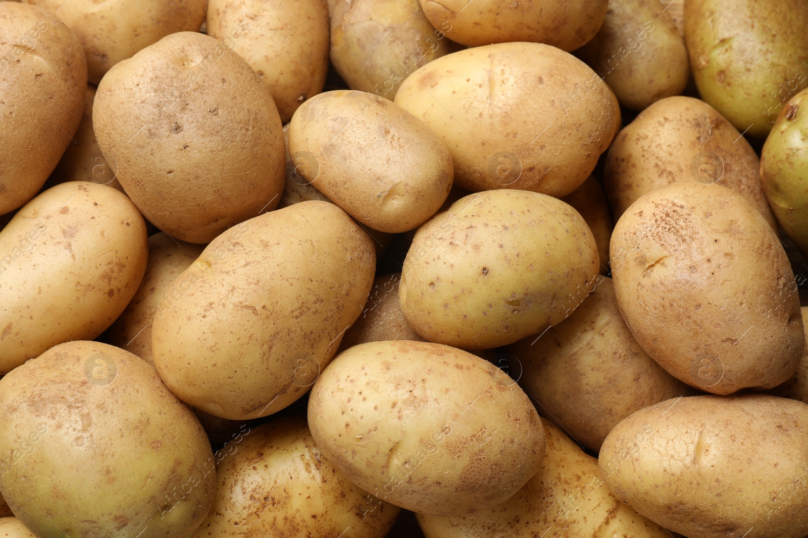 Photo of Fresh raw potatoes as background, top view