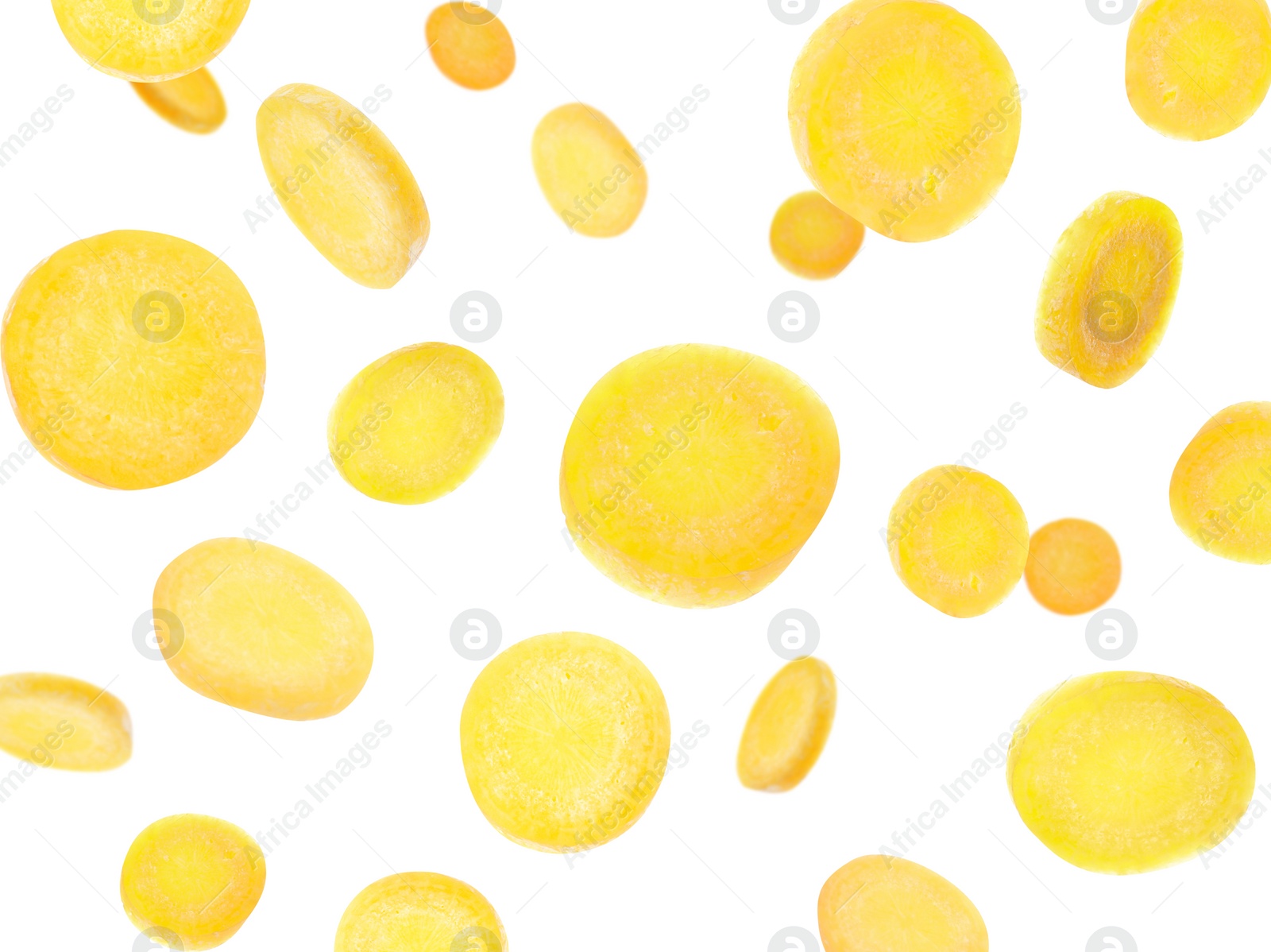 Image of Yellow carrot slices falling on white background