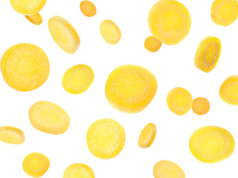 Yellow carrot slices falling on white background