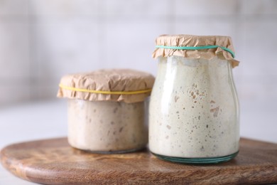 Photo of Sourdough starter in glass jars on table