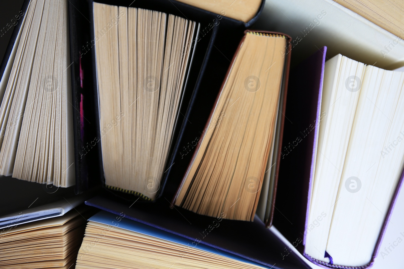 Photo of Collection of different hardcover books, closeup view