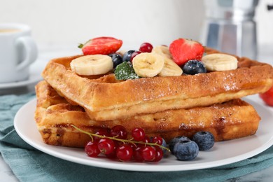 Photo of Delicious Belgian waffles with berries and banana on plate, closeup