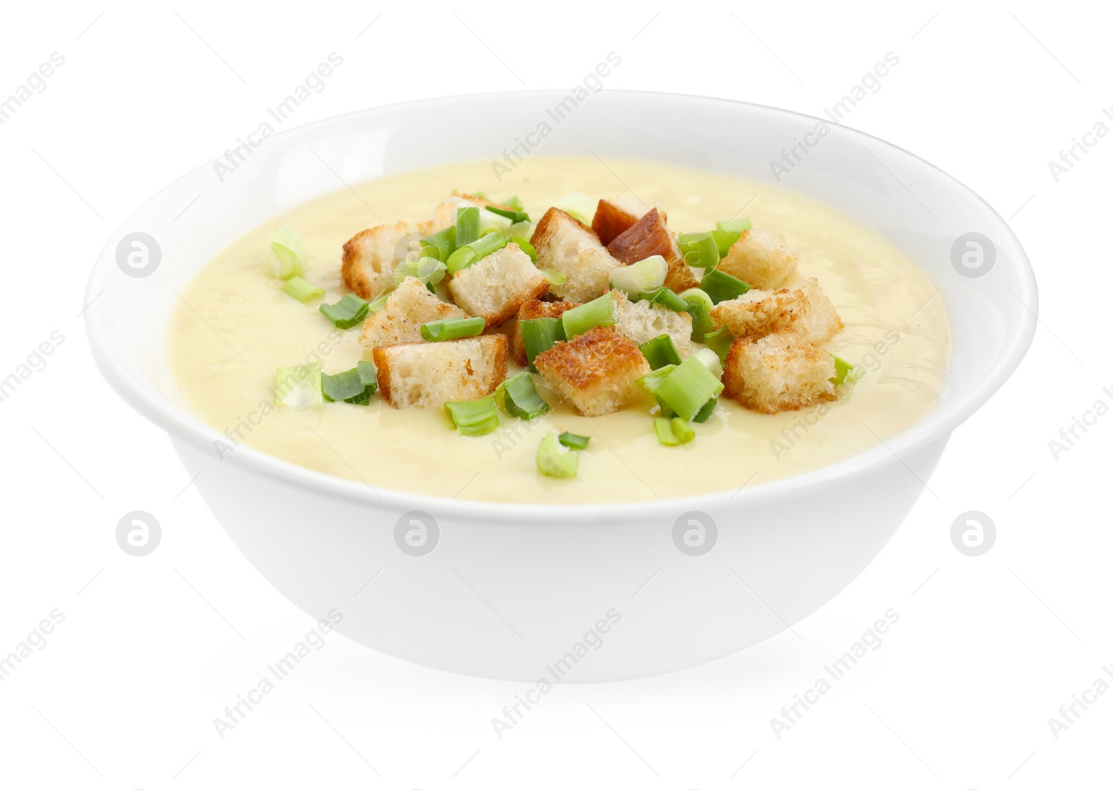 Photo of Tasty potato soup with croutons and green onion in bowl isolated on white