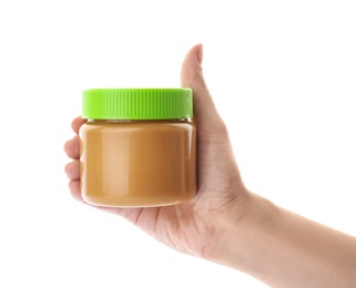 Photo of Woman holding jar with creamy peanut butter on white background